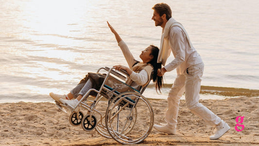 man pushing a woman in a wheelchair